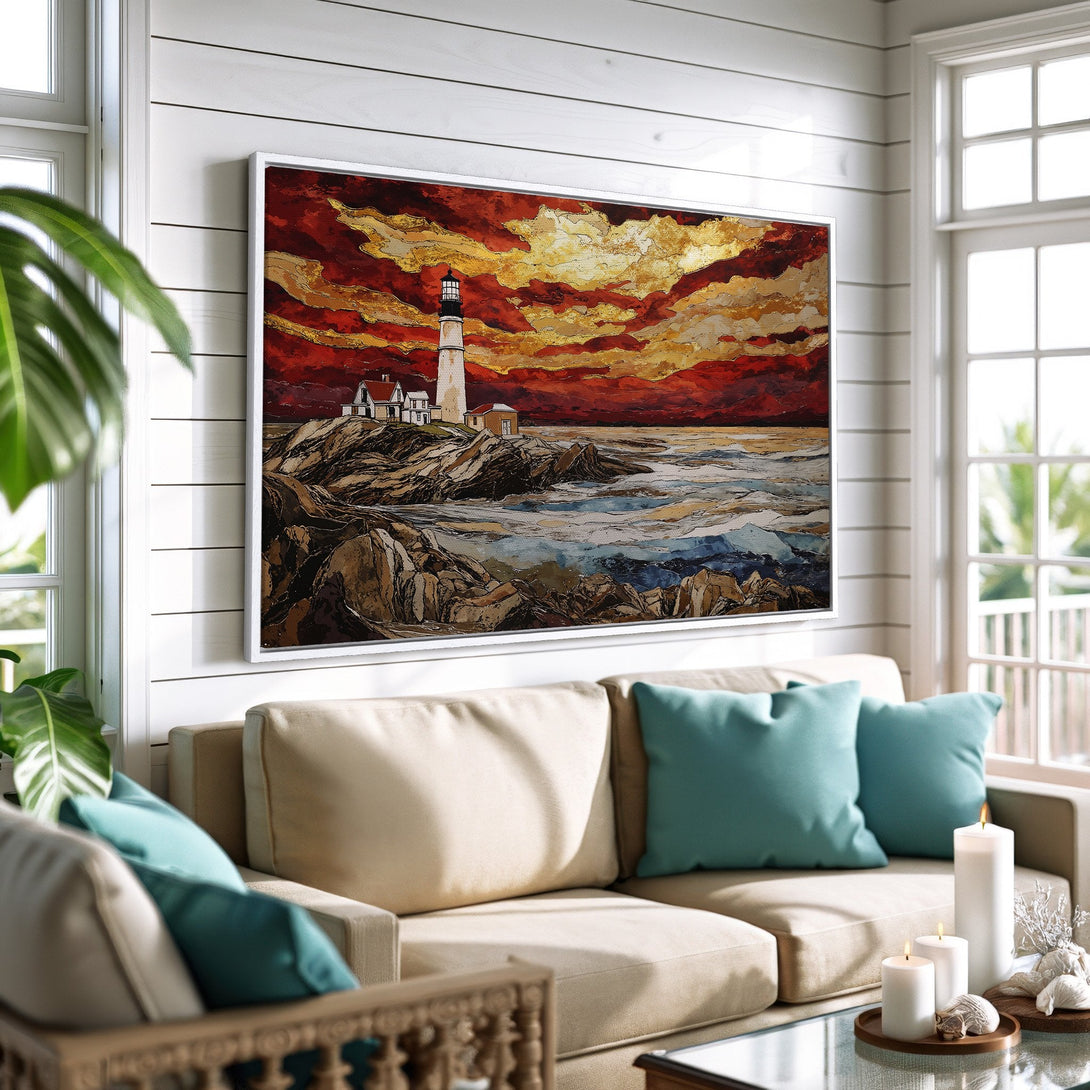 Framed Wall Art of a lighthouse painting with a fiery sunset. Coastal style art with warm red, gold, and blue tones. Perfect for living room decor.