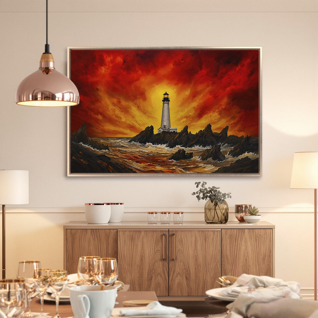 Framed Wall Art: Lighthouse painting with fiery red and yellow sky. Coastal artwork in a dining room setting. Dramatic and captivating.