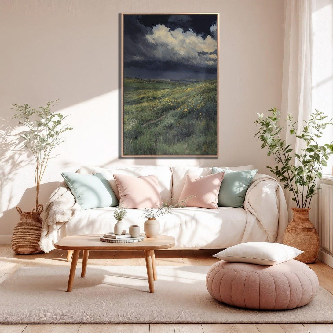 Framed Wall Art featuring a landscape painting with a dramatic sky and green fields. Warm neutral color palette complements the cozy interior.