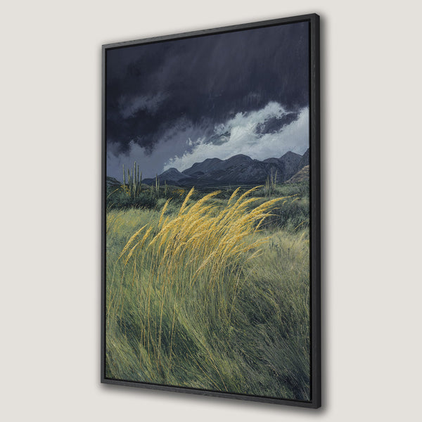 Framed Wall Art featuring a desert landscape with dramatic sky, golden grasses, and mountains. Earthy tones of green, yellow, and gray create a serene, natural aesthetic.