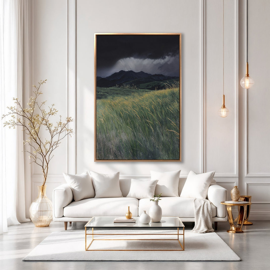 Framed Wall Art: Dramatic landscape canvas print with dark mountain and green field. Modern interior decor with gold accents and neutral palette.