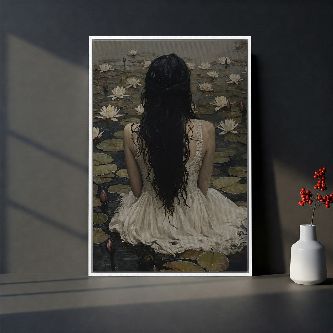 Framed Wall Art: Woman in white dress on canvas, serene scene with water lilies, muted color palette, perfect for adding a touch of elegance to your home decor.