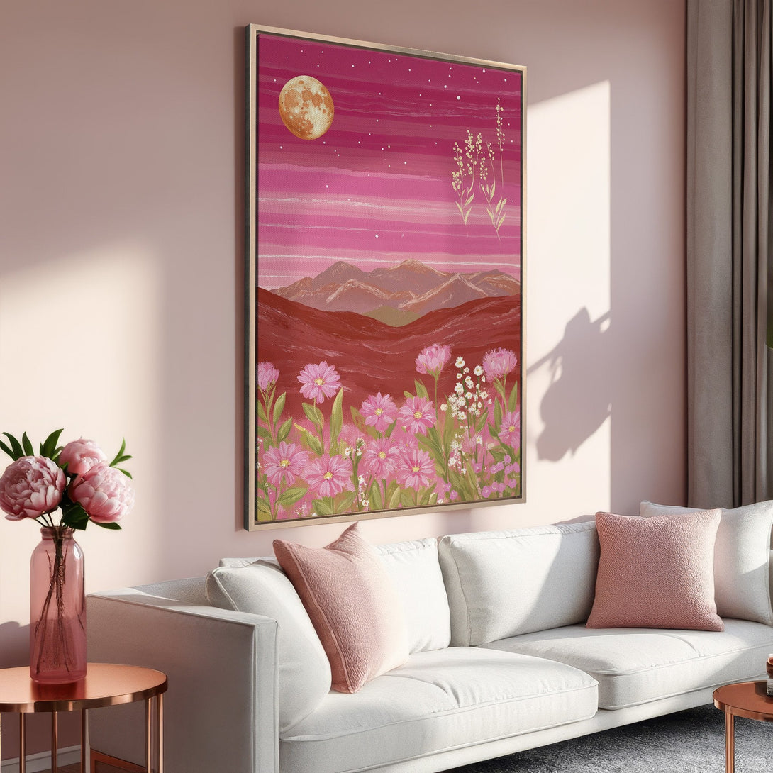 Framed Wall Art featuring a dreamy landscape with pink flowers, mountains, and a moon. Adds a touch of serenity with its warm, pink color palette.