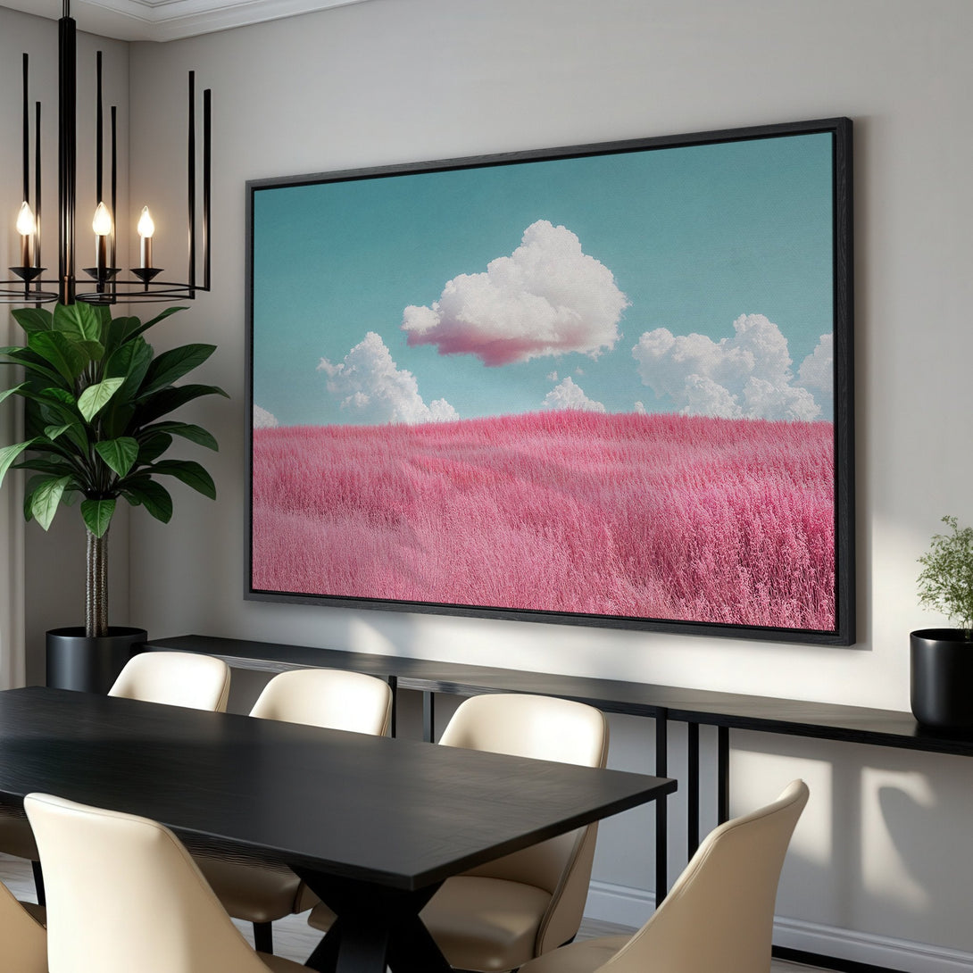 Framed Wall Art: Pink field canvas print with a vibrant teal sky and fluffy clouds. Modern art in a dining room, featuring a black frame and a bold color palette.