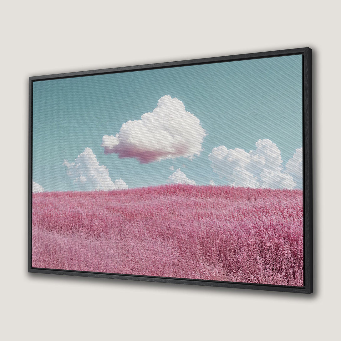 Framed Wall Art featuring a dreamy landscape with pink field, white clouds, and blue sky. Perfect for adding a pop of color and serenity to your space.
