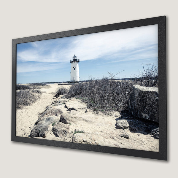 Framed Poster featuring a lighthouse on a beach. Coastal style with a blue, beige, and gray color palette. Perfect wall art for your home!