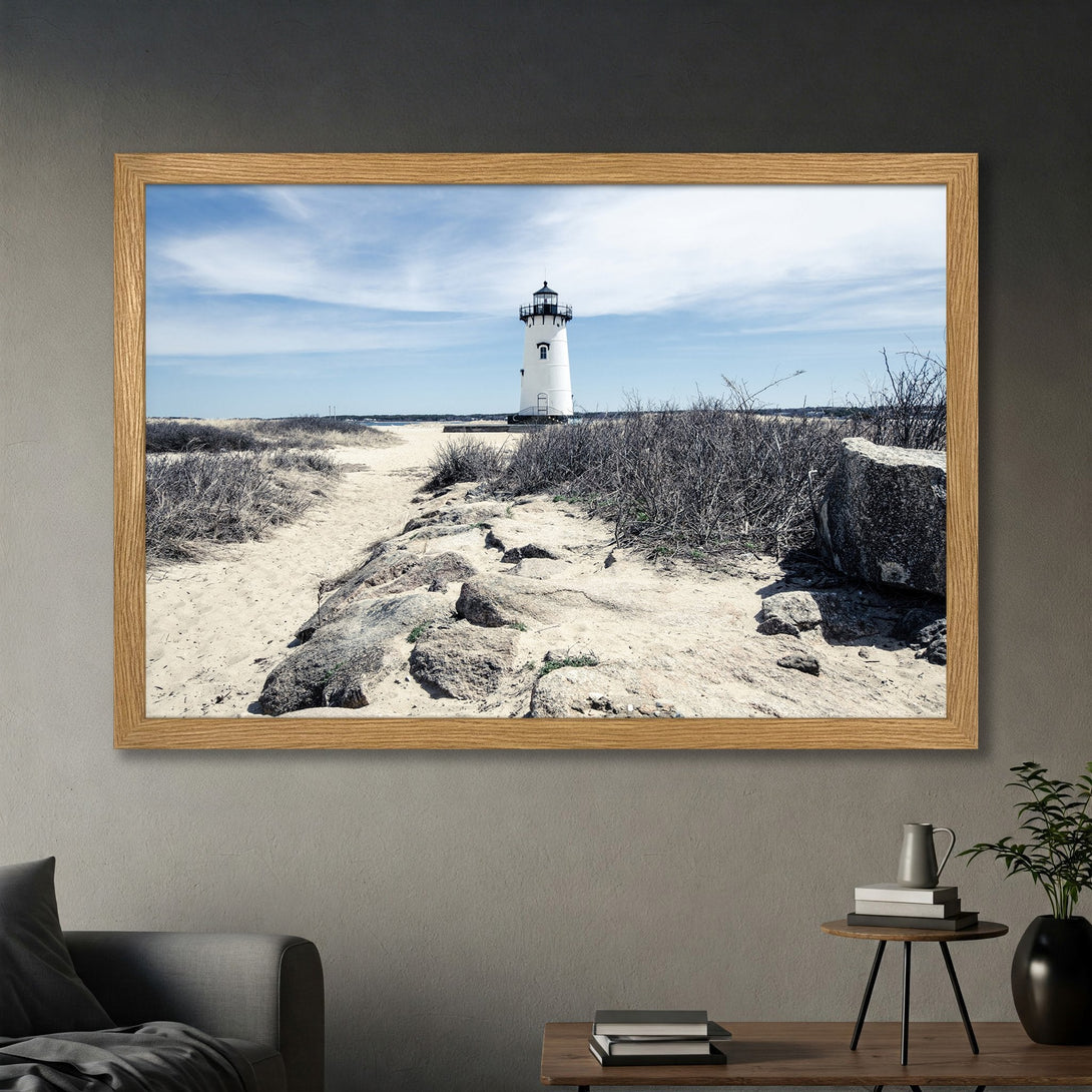 Framed Poster of a lighthouse on a beach. Coastal style with neutral tones and blue sky. Bring the serenity of the sea to your home.