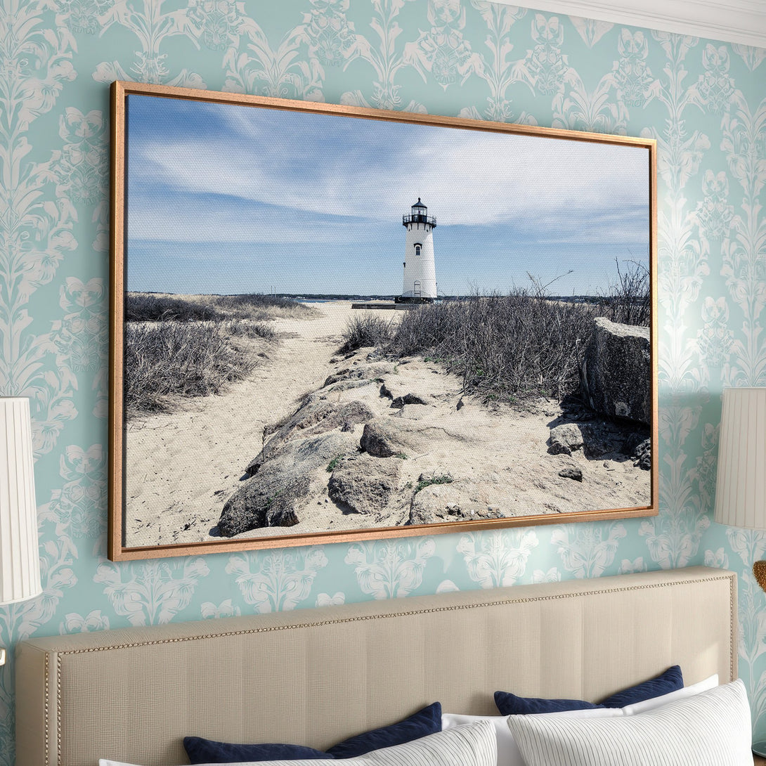 Framed Wall Art: Coastal lighthouse Canvas Print in neutral tones. Perfect for a serene bedroom. Bring the beach vibes home!