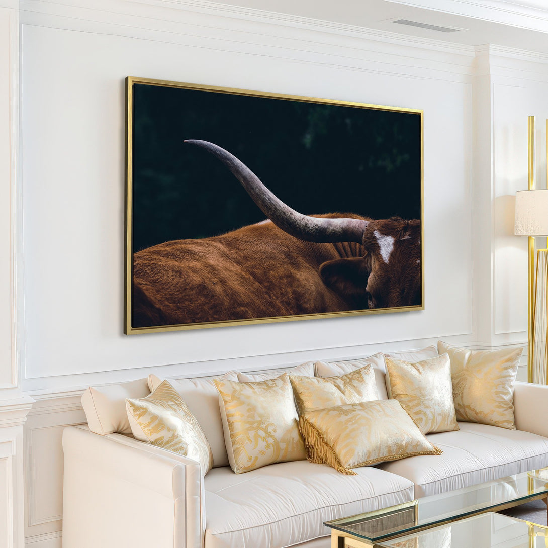 Canvas Print featuring a close-up of a Texas Longhorn in a minimalist, modern living room. Earthy tones and a dark background create a striking focal point.