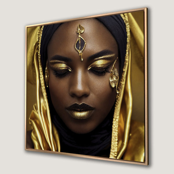 Framed Wall Art of a woman with gold makeup and head covering. Rich gold and black palette. Perfect statement piece for your home.