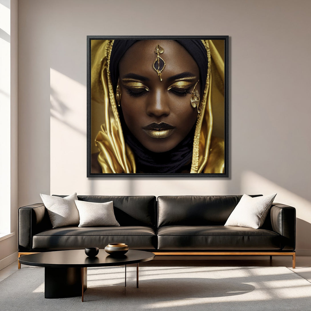 Framed Wall Art: Stunning portrait of a woman with gold makeup and accents, displayed in a modern living room. Warm gold and black color palette.