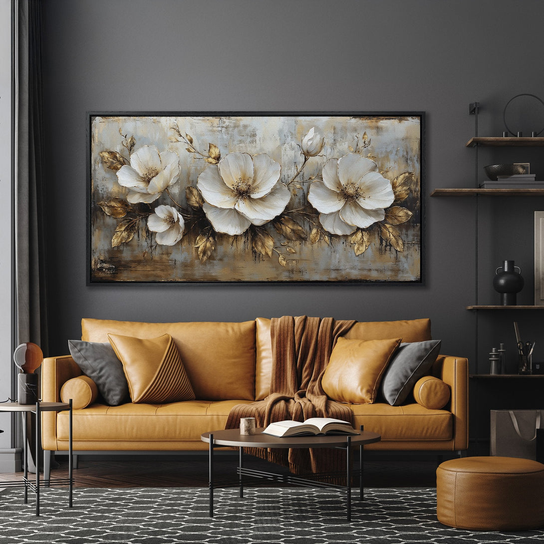 Framed Wall Art: Elegant floral canvas print in neutral tones with gold accents. Modern art for living room decor, displayed above a stylish leather sofa.