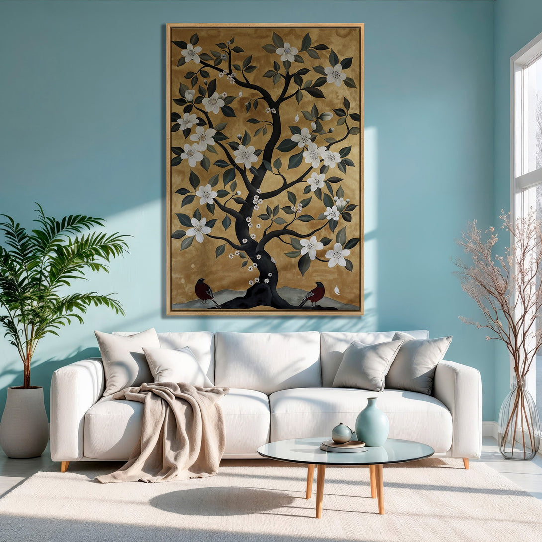 Framed Wall Art: Elegant tree painting with white flowers, gold background, and birds. Perfect for a modern living room with a calming blue and neutral palette.