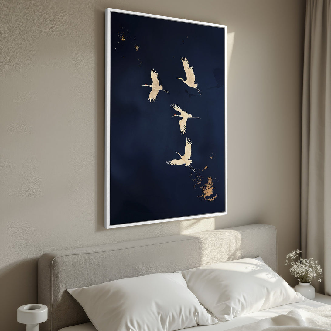 Framed Wall Art of cranes in flight on a navy blue background. Elegant, modern art with gold accents, perfect for bedroom decor.