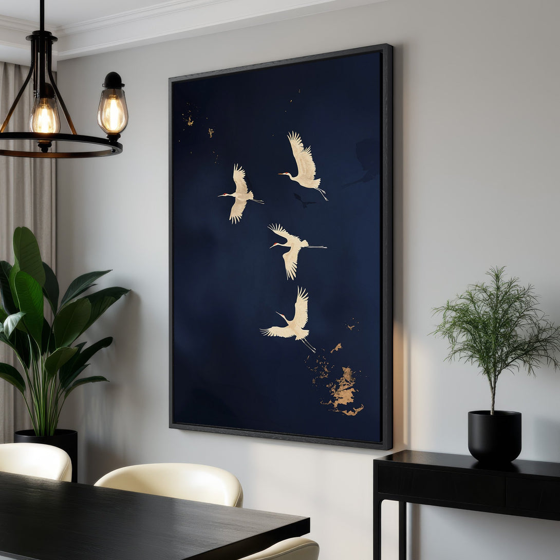 Framed Wall Art featuring serene cranes in flight against a deep blue backdrop. Modern, minimalist style with gold accents. Perfect for adding elegance to your space.