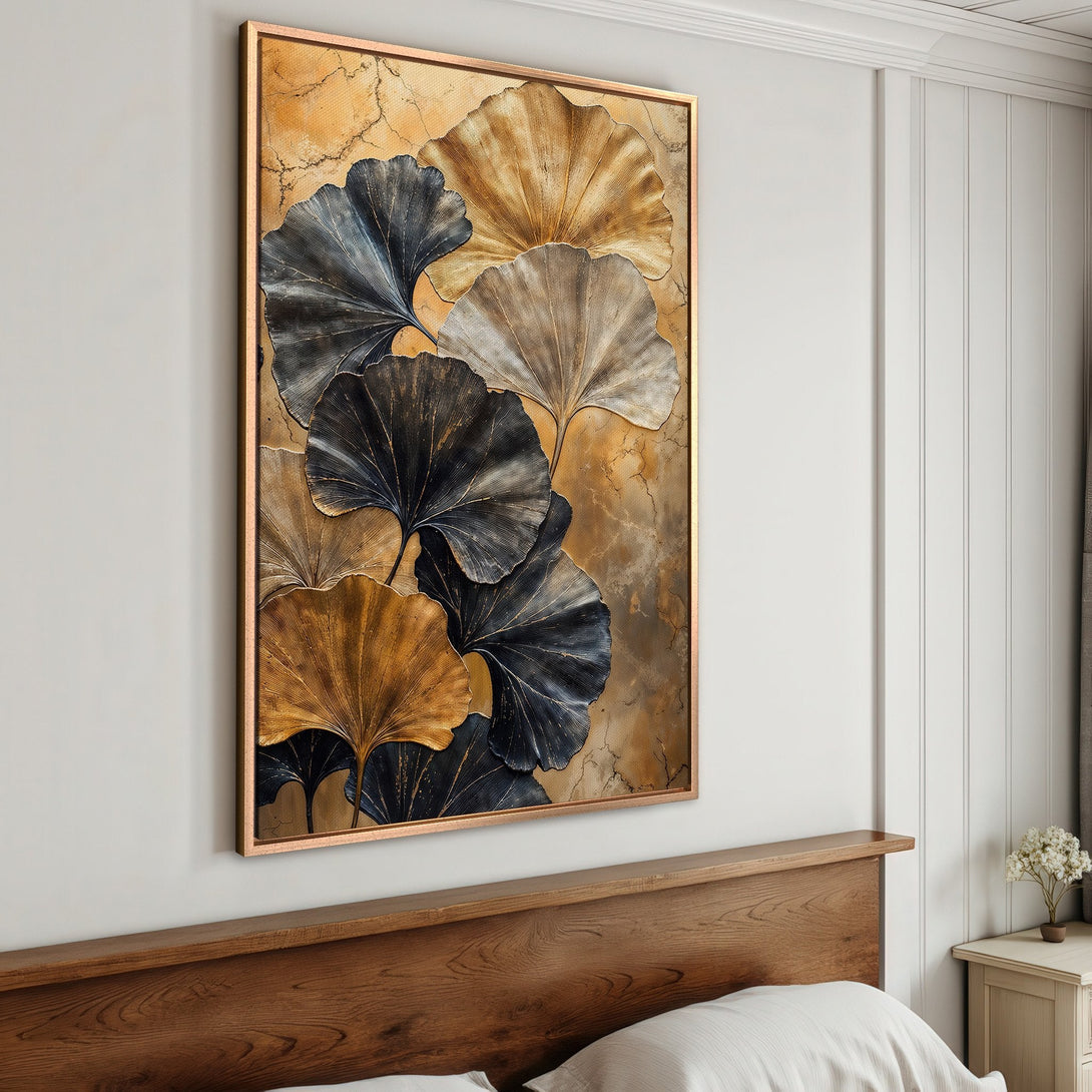 Framed Wall Art featuring elegant gold and navy ginkgo leaves. Adds a touch of modern art to any bedroom. Warm, neutral color palette.