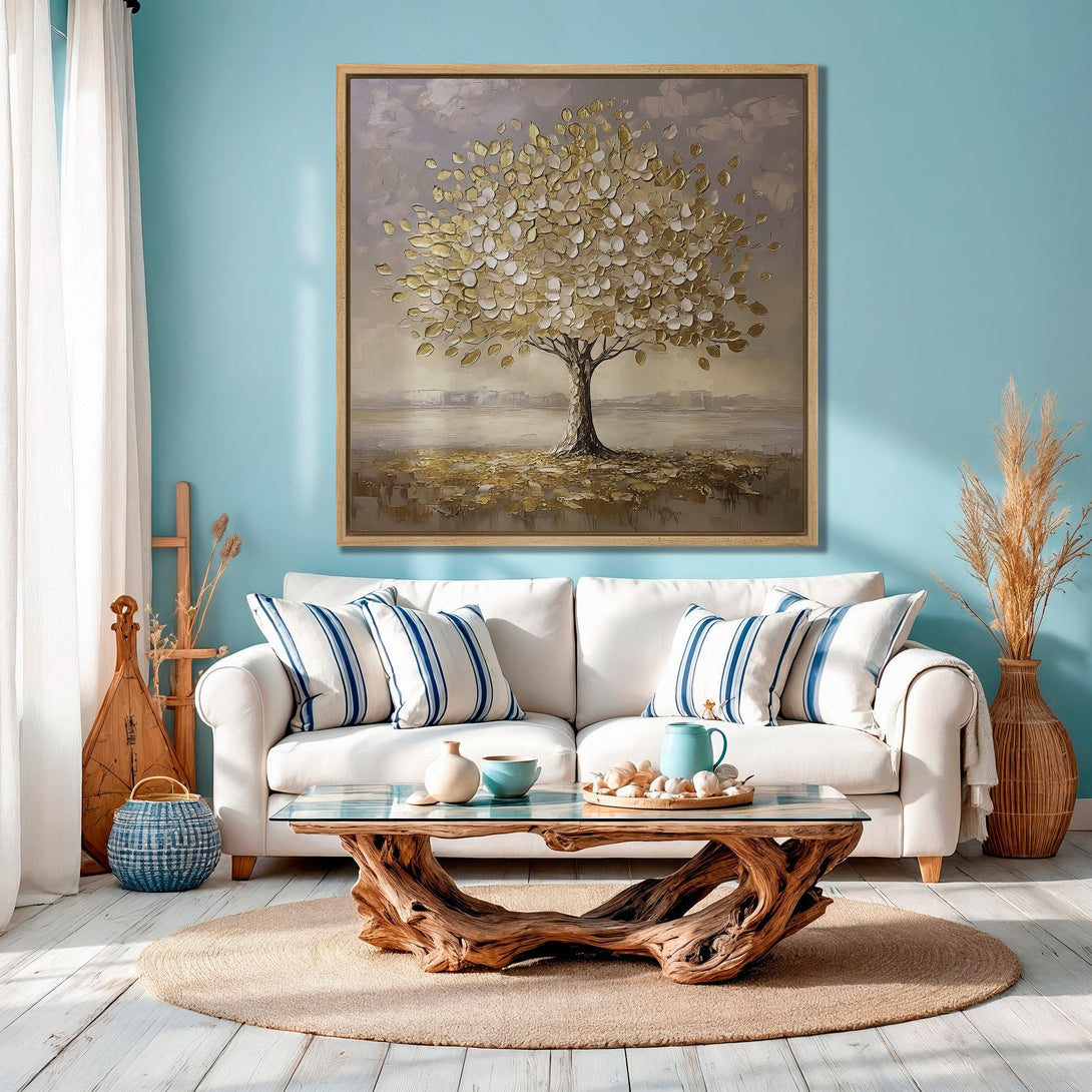 Framed Wall Art: Gold leaf tree painting in a serene living room. Neutral & blue color palette, perfect for coastal decor. Bring nature indoors!