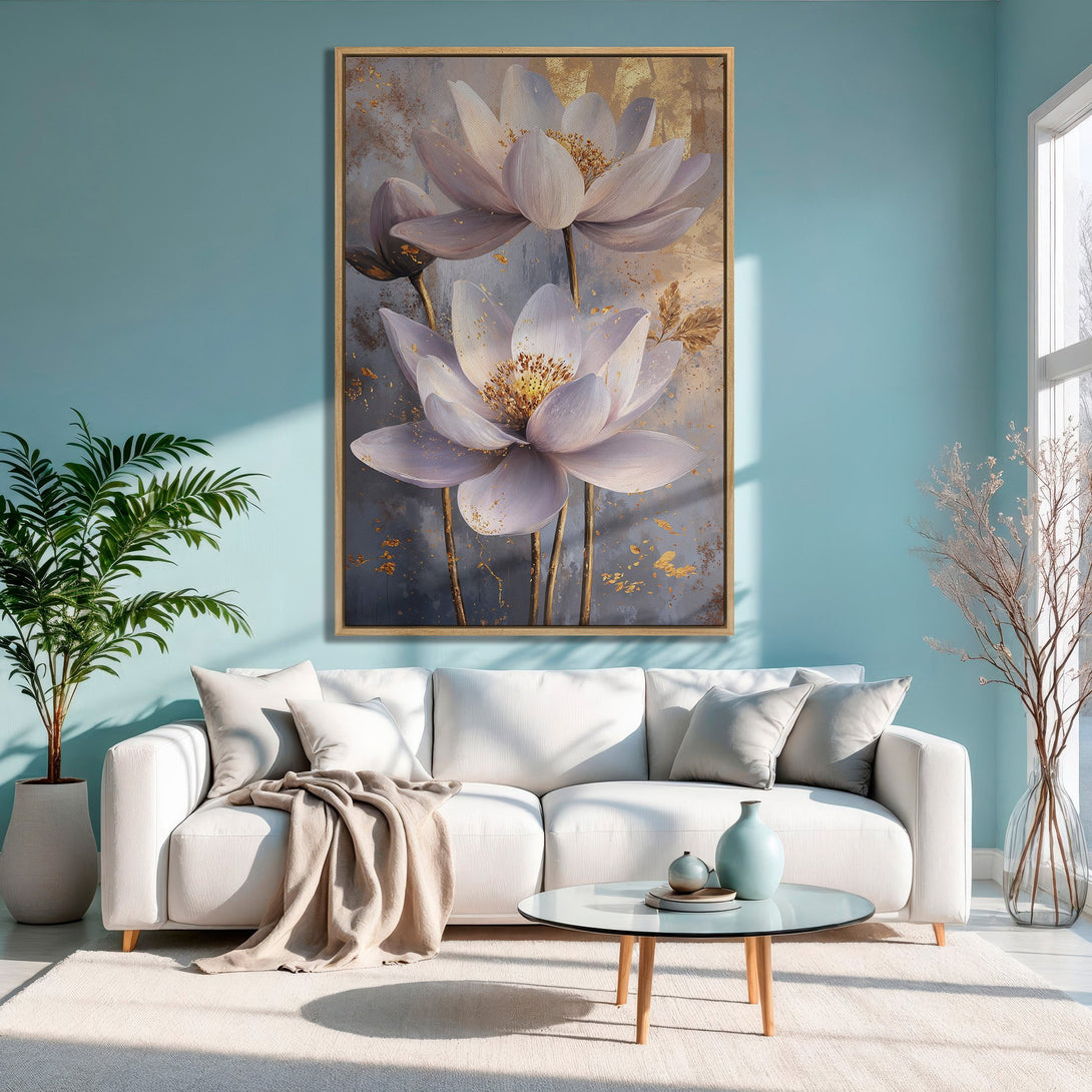 Framed Wall Art: Floral canvas print with gold accents, displayed in a modern living room. Soft, pastel color palette with blue and white tones.