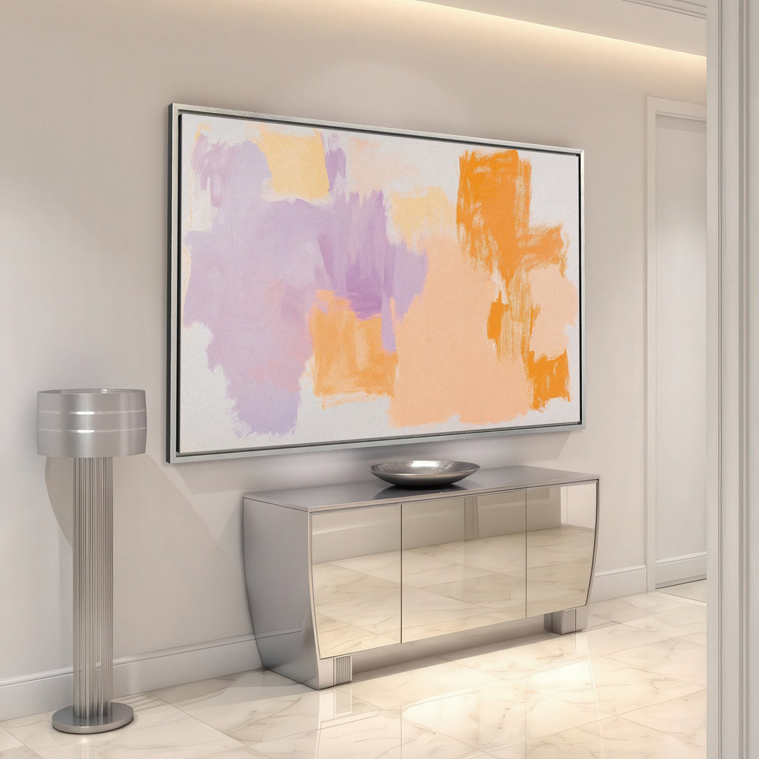 Framed Wall Art: Abstract canvas print in a modern interior. Features a warm, pastel color palette with orange, purple, and peach brushstrokes. Elevate your space!
