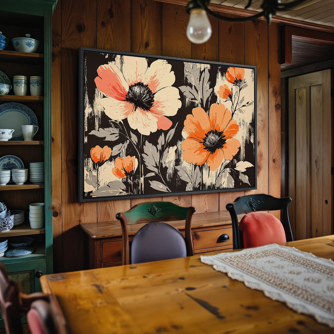 Framed Wall Art: Floral Canvas Print in a rustic interior. Features large orange and cream flowers on a black background. Adds warmth and style to any room.