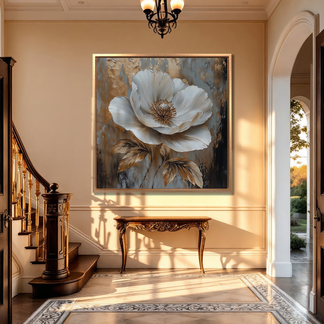 Framed Wall Art featuring a large white flower with gold accents. Elegant canvas print in a neutral color palette, perfect for sophisticated home decor.