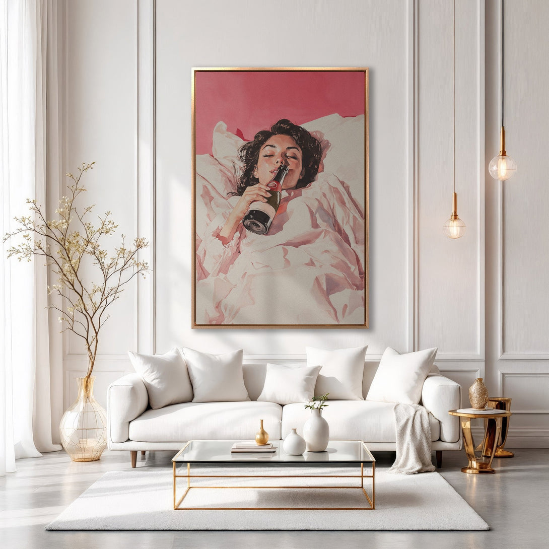 Framed Wall Art featuring a woman drinking champagne in bed, blush pink and gold color palette, perfect for modern home decor.