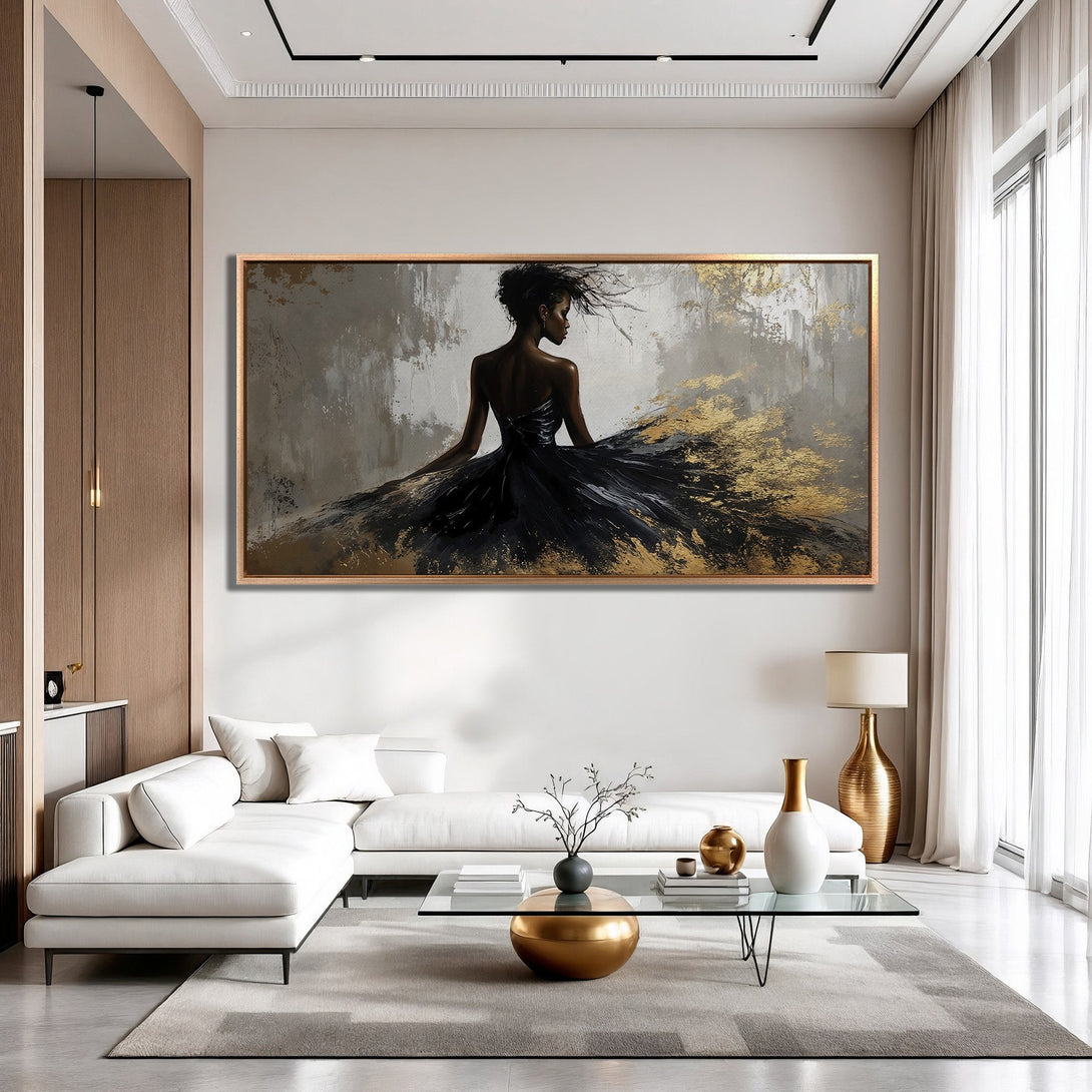 Framed Wall Art featuring a woman in a black dress with gold accents, displayed in a modern living room. Neutral color palette with pops of gold.