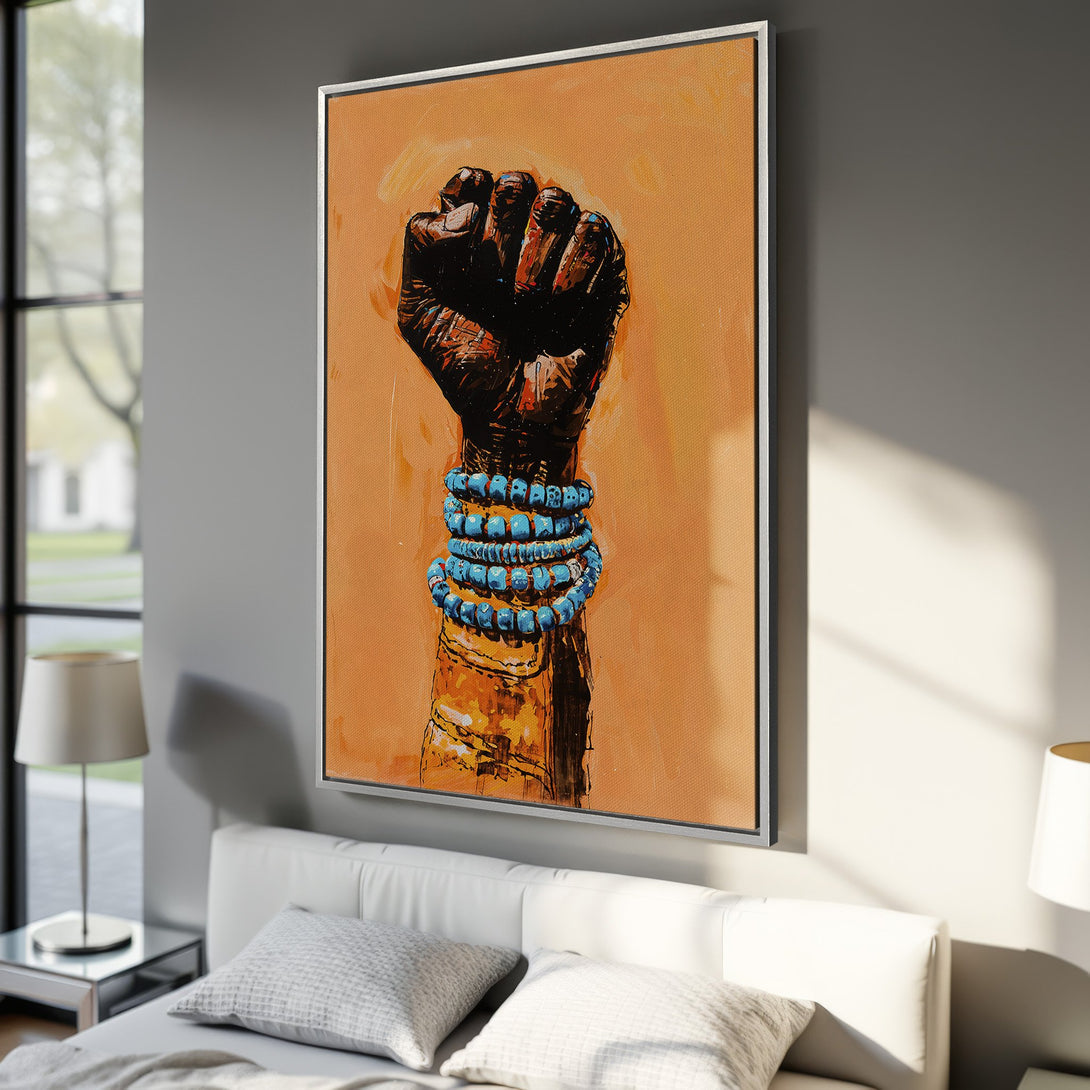 Framed Wall Art featuring a powerful fist with blue bracelets. Warm orange and brown tones create a bold, expressive artwork for your home decor.