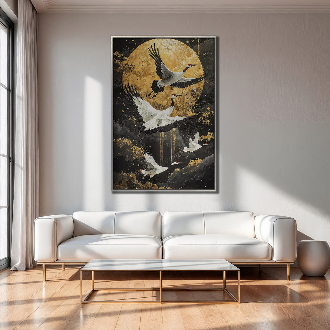 Framed Wall Art: Cranes flying in front of a golden moon. Japanese-inspired art with black, gold, and white color palette. Perfect for modern decor.