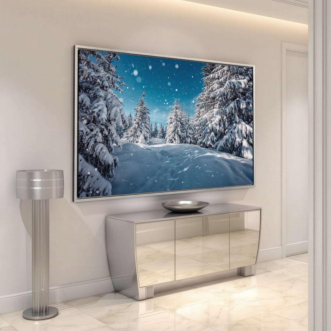 Framed Wall Art featuring a snowy winter forest scene. Blue and white color palette. Perfect for a cozy, modern interior.
