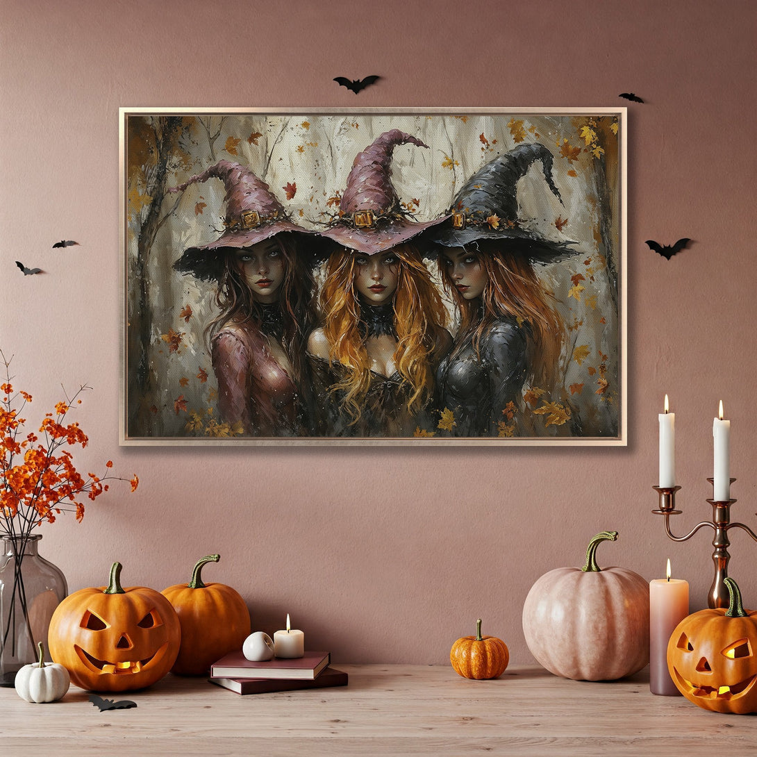 Framed Wall Art: Three witches in a mystical, autumnal scene. Featuring a warm color palette, perfect for Halloween decor.