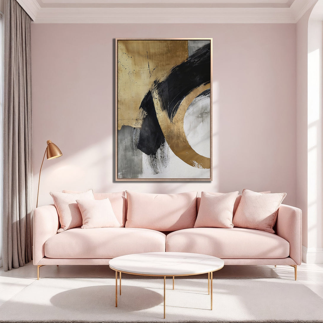 Framed Wall Art: Abstract gold, black, and gray brushstrokes on canvas. Modern art piece in a blush pink living room. Elevate your space with stylish art.