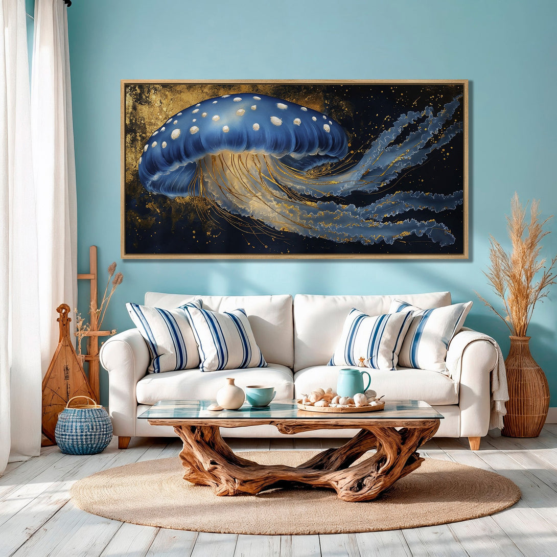Framed Wall Art: Blue jellyfish painting in a modern coastal living room. Gold & blue color palette creates a serene, artistic vibe.