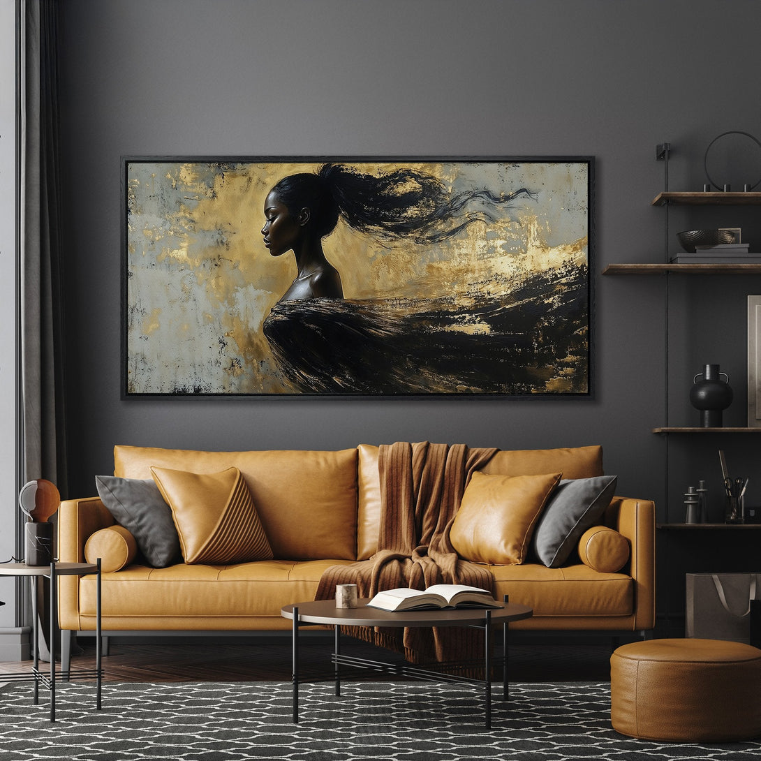 Framed Wall Art featuring an elegant woman with flowing hair, abstract style, gold & black palette, displayed in a modern living room.