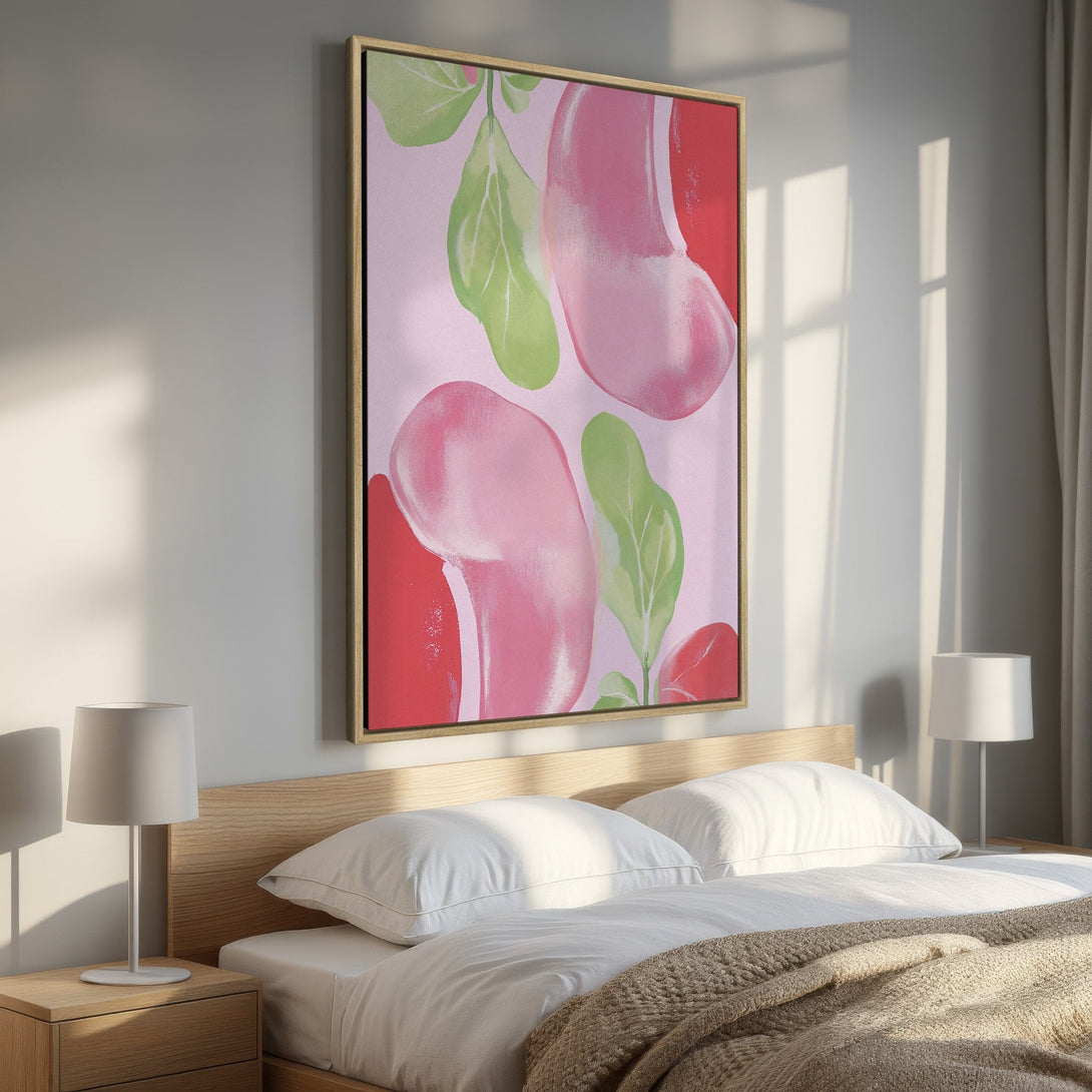 Framed Wall Art featuring abstract pink and green shapes. Modern art canvas print adds a pop of color to a bedroom with a soft, pastel palette.