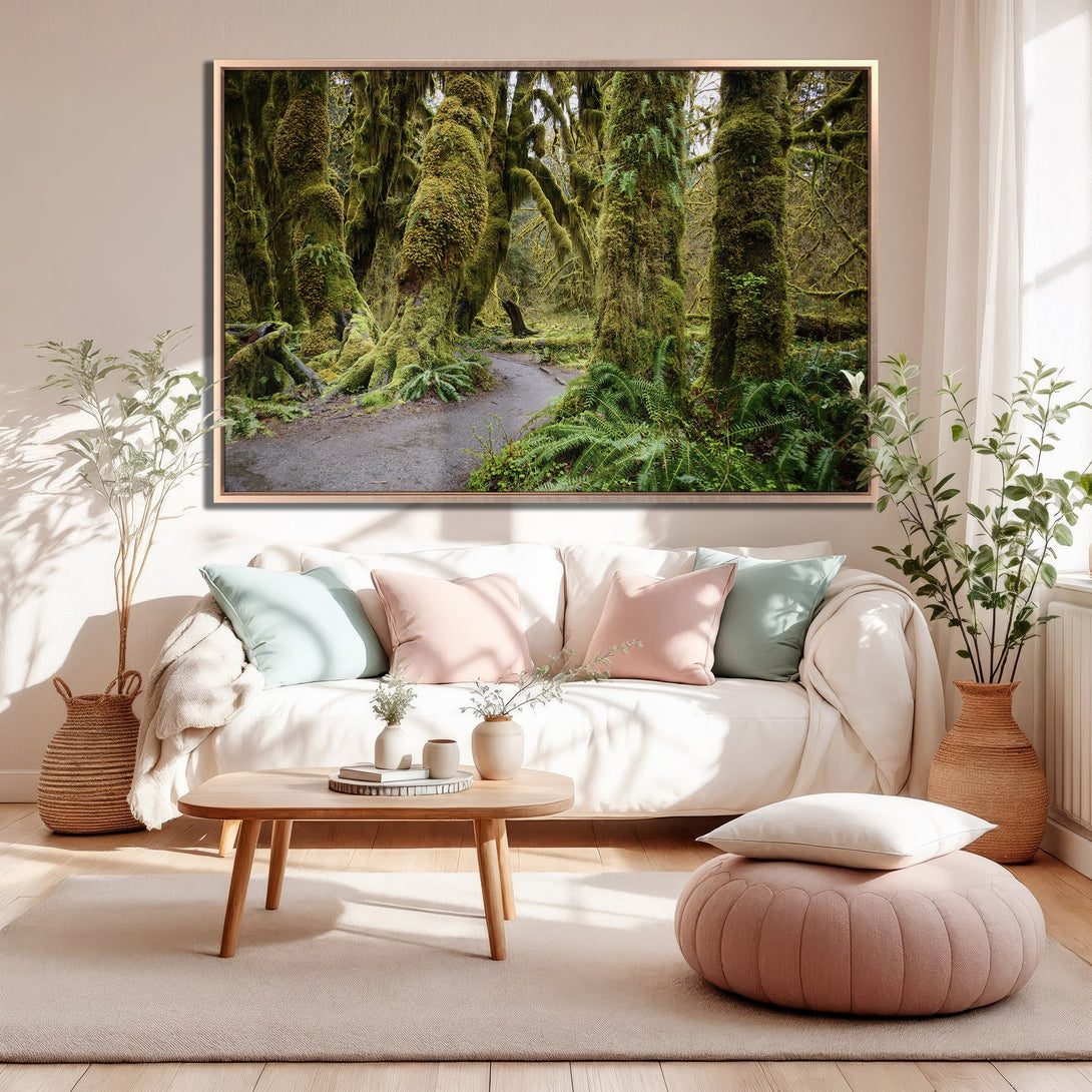 Framed Wall Art: Lush green forest scene canvas print in a cozy living room. Nature-inspired art with a calming green and neutral color palette.