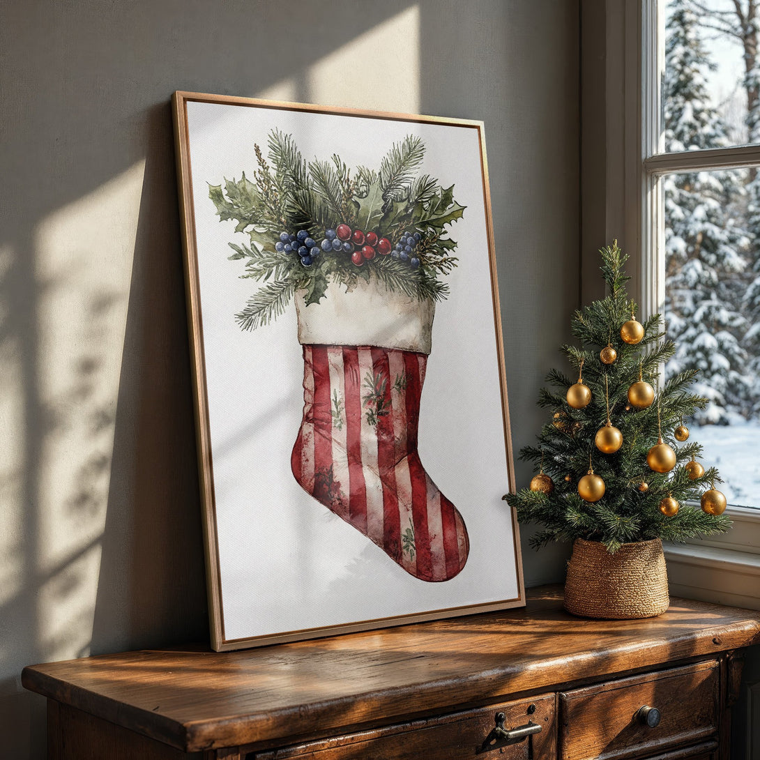 Framed Wall Art featuring a watercolor Christmas stocking with red & white stripes, greenery, & berries. Perfect holiday decor, warm color palette.
