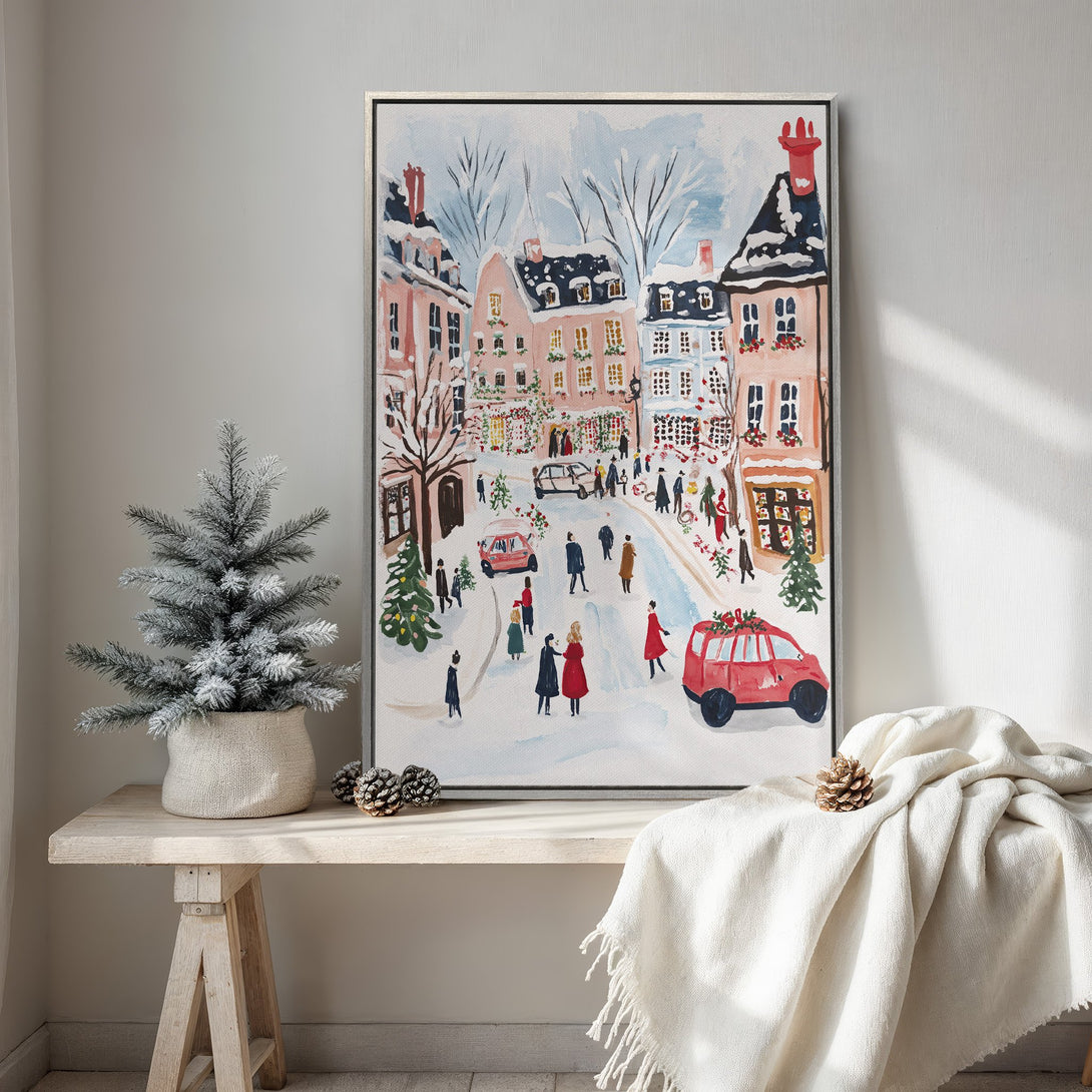 Framed Wall Art: Watercolor painting of a snowy European street scene. Pastel pink and blue color palette creates a cozy, festive atmosphere. Perfect holiday decor.