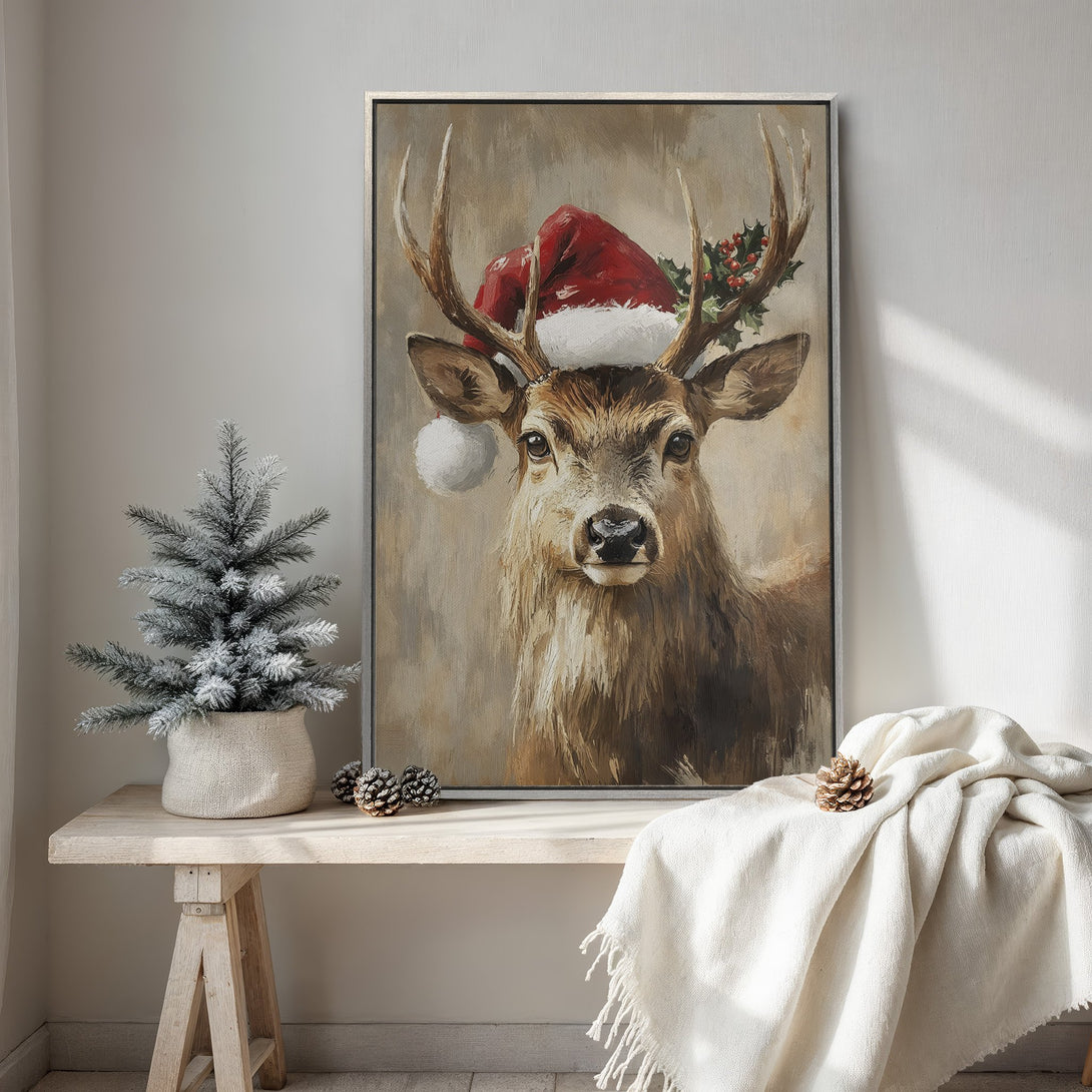 Framed Wall Art of a deer wearing a Santa hat. Rustic style with warm brown and red tones, perfect for Christmas decor.