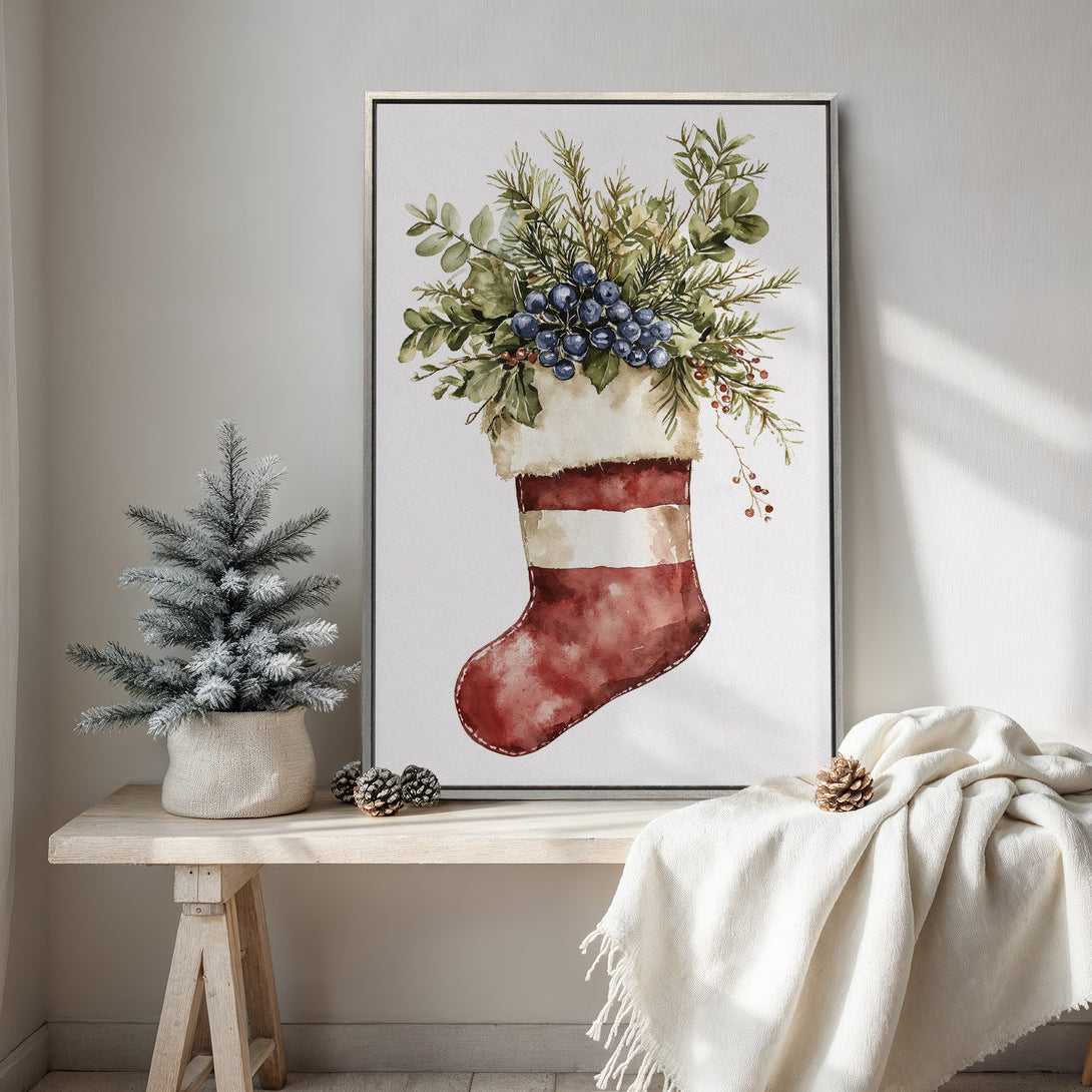 Framed Wall Art featuring a watercolor Christmas stocking with greenery and berries, warm red and green tones, perfect for holiday decor.