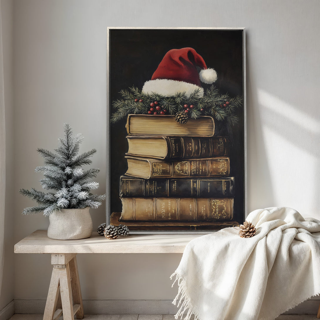 Framed Wall Art featuring a festive stack of books with a Santa hat. Warm, inviting color palette with red, gold, and brown tones. Perfect holiday decor!