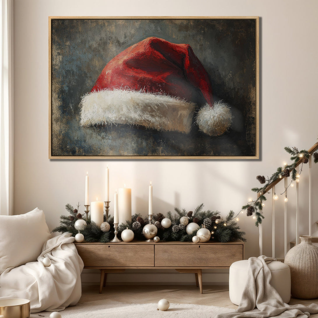 Framed Wall Art featuring a Santa hat in a painterly style with a red, white, and neutral color palette. Perfect for adding festive cheer to your home!