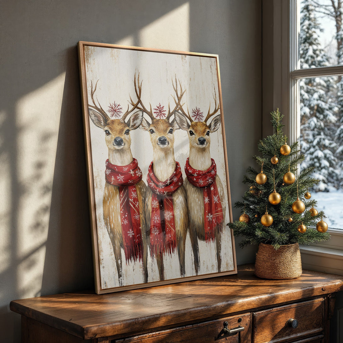 Framed Wall Art: Festive watercolor painting of three deer in red scarves. Warm, inviting color palette perfect for holiday decor. Shop now!