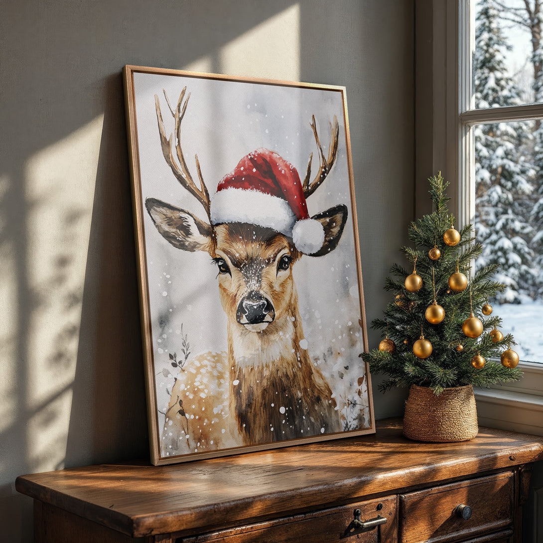 Framed Wall Art: Watercolor deer in Santa hat. Warm, neutral tones with pops of red. Perfect Christmas decor!