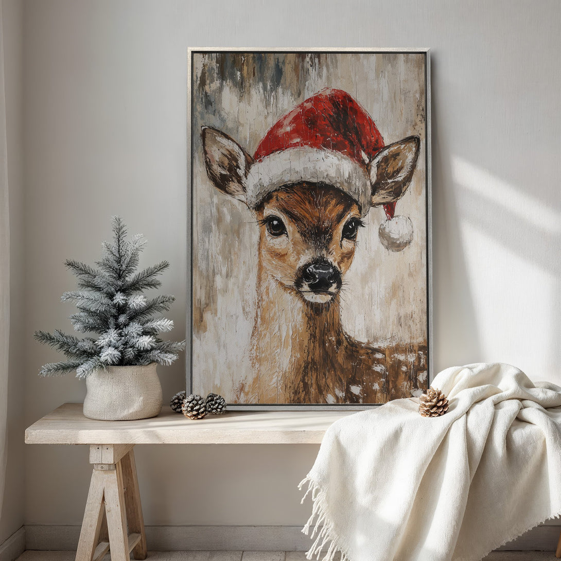 Framed Wall Art: Festive deer in Santa hat. Rustic style canvas print with warm brown, red, and cream color palette. Perfect for Christmas decor!