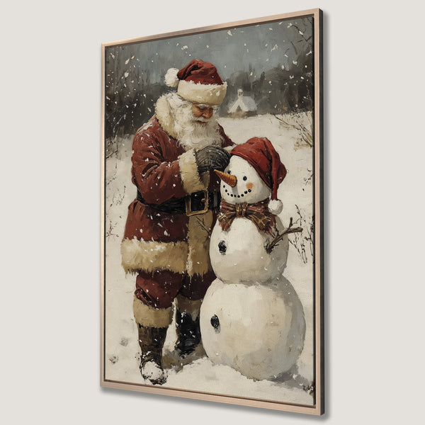 Framed Wall Art featuring Santa Claus building a snowman in a snowy landscape. Warm red and neutral tones create a cozy, vintage-style Christmas scene.