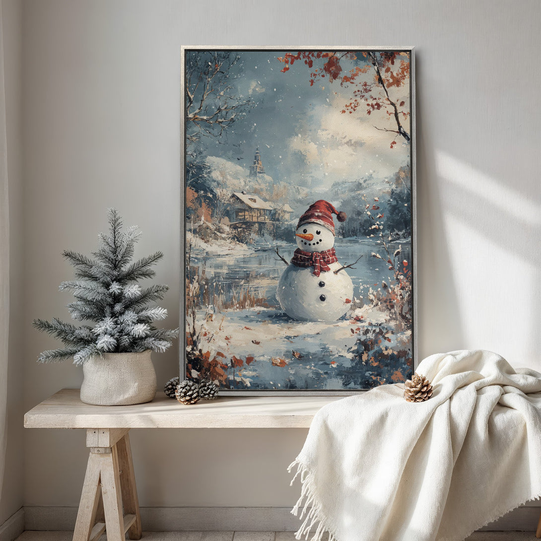 Framed Wall Art: Winter scene Canvas Print with a snowman in a snowy landscape, featuring blue, white, and red hues. Perfect for holiday decor!