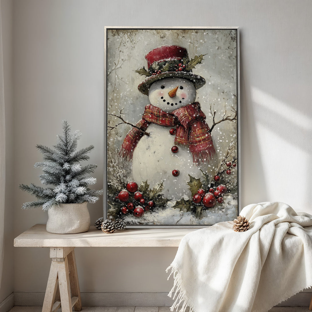 Framed Wall Art of a charming snowman in a snowy scene. Rustic style with a red, white, and green color palette. Perfect for holiday decor.