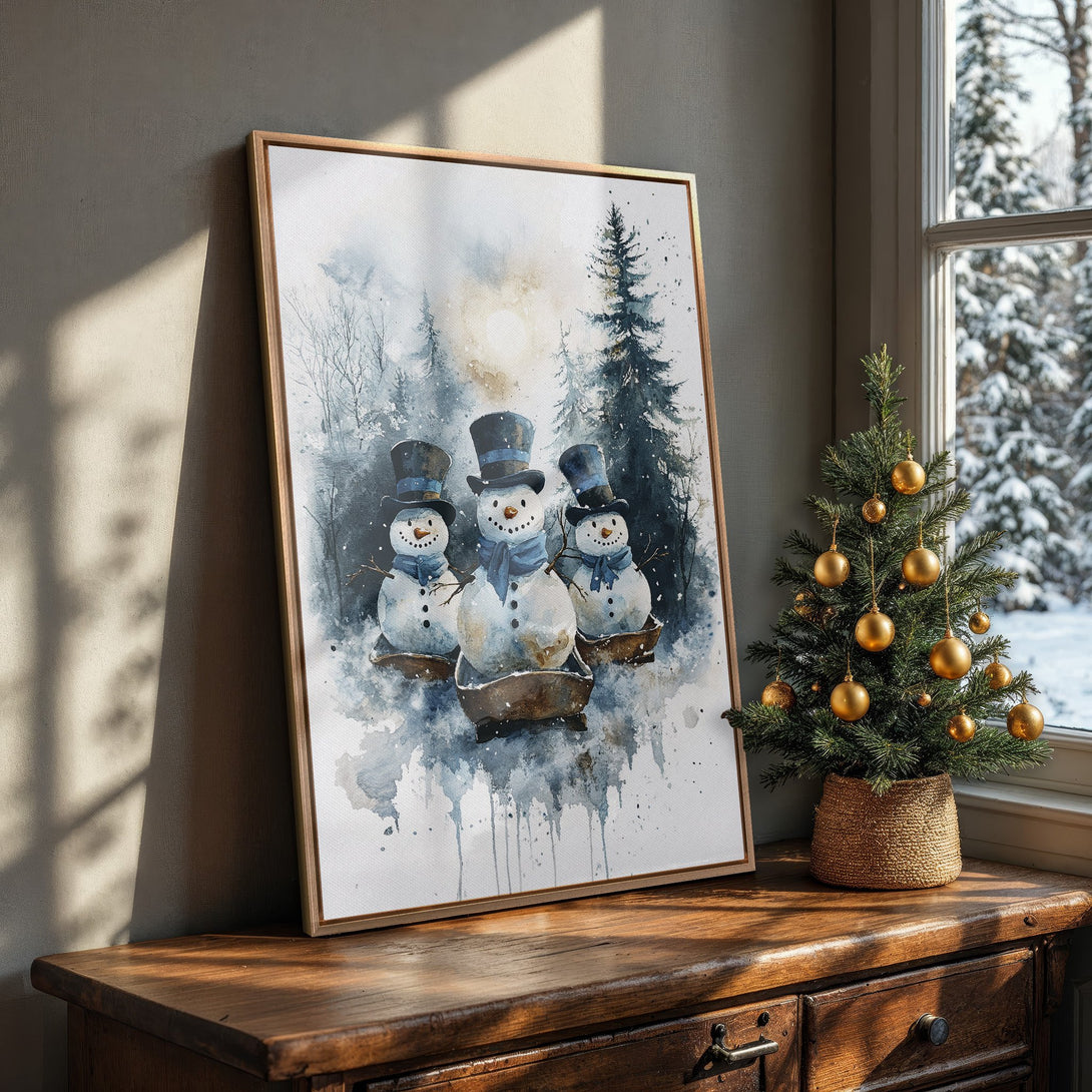 Framed Wall Art featuring watercolor snowmen in a winter forest scene. Soft blue and gray color palette, perfect for seasonal home decor.