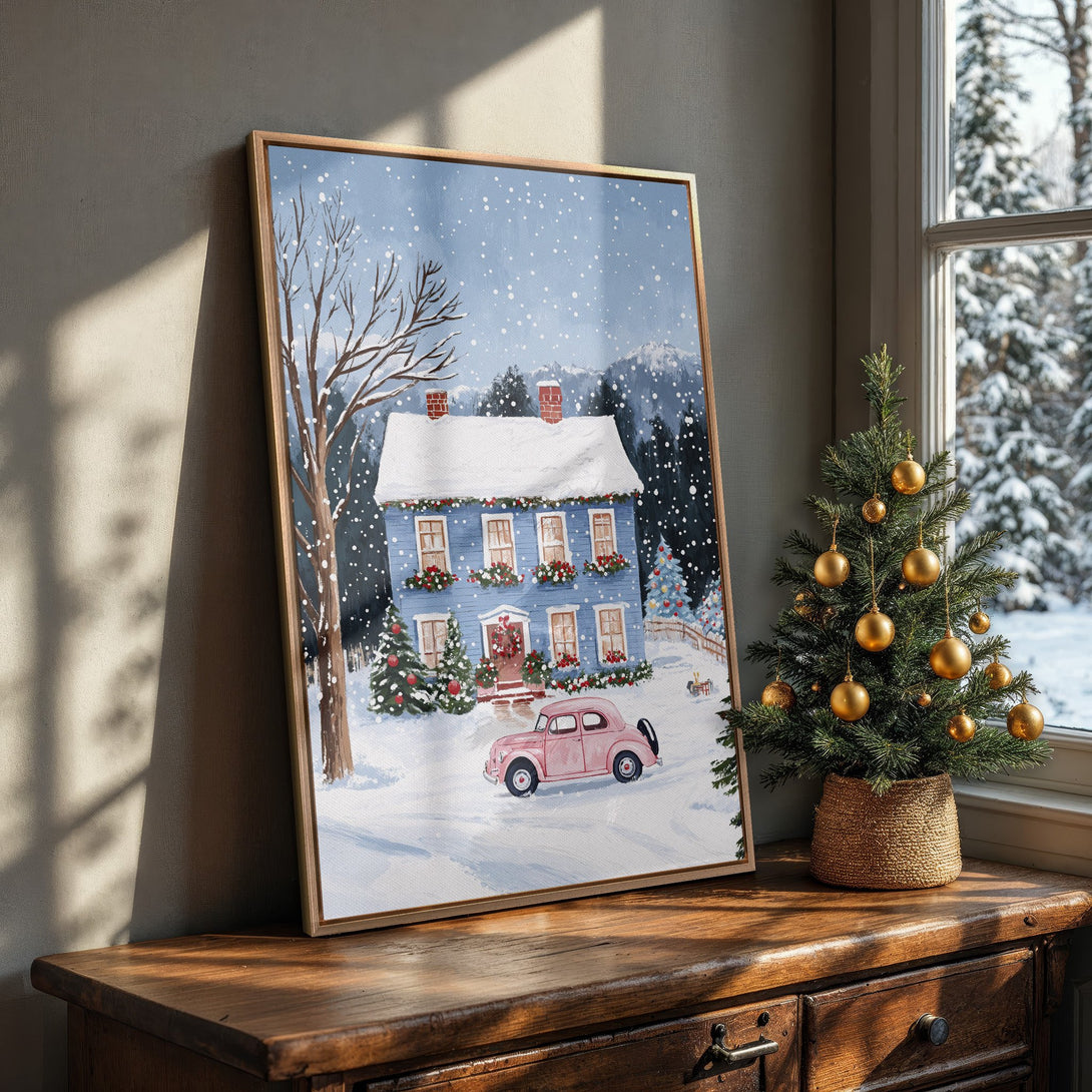Framed Wall Art featuring a charming winter scene with a blue house, pink car, and snow. A cozy, festive painting with a cool color palette.